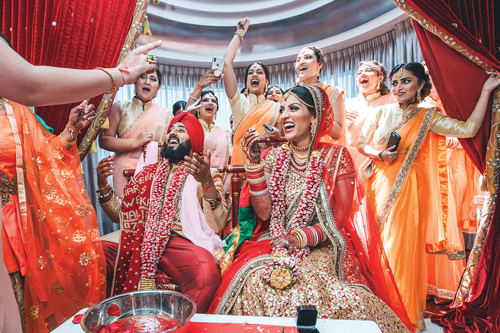 Joyful Indian wedding celebration with bride, groom, and family dressed in traditional attire, illustrating the cultural richness, communal spirit, and elaborate rituals that define Indian weddings and men’s wedding outfits.