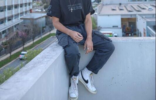 Men wearing a 6-pockets cargo pants with a relaxed fit and utility pockets, illustrating rugged, functional trousers made from cotton or canvas and styled for casual, utilitarian menswear.