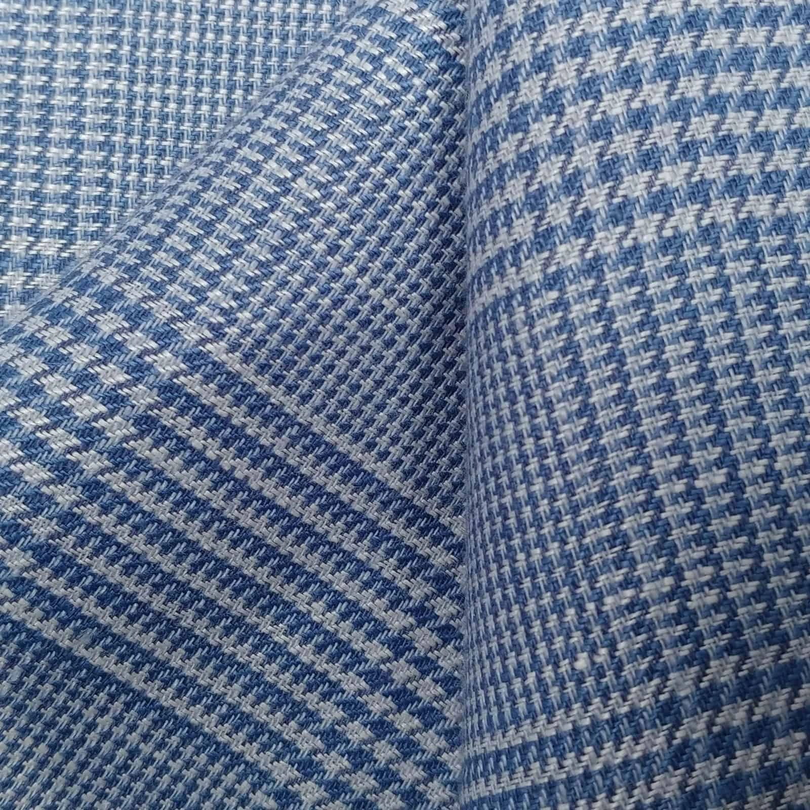 Blue check linen suiting fabric, close-up showing crisp weave structure and soft hand feel, lightweight breathable linen ideal for tailored jackets, summer suits, and refined business casual menswear.