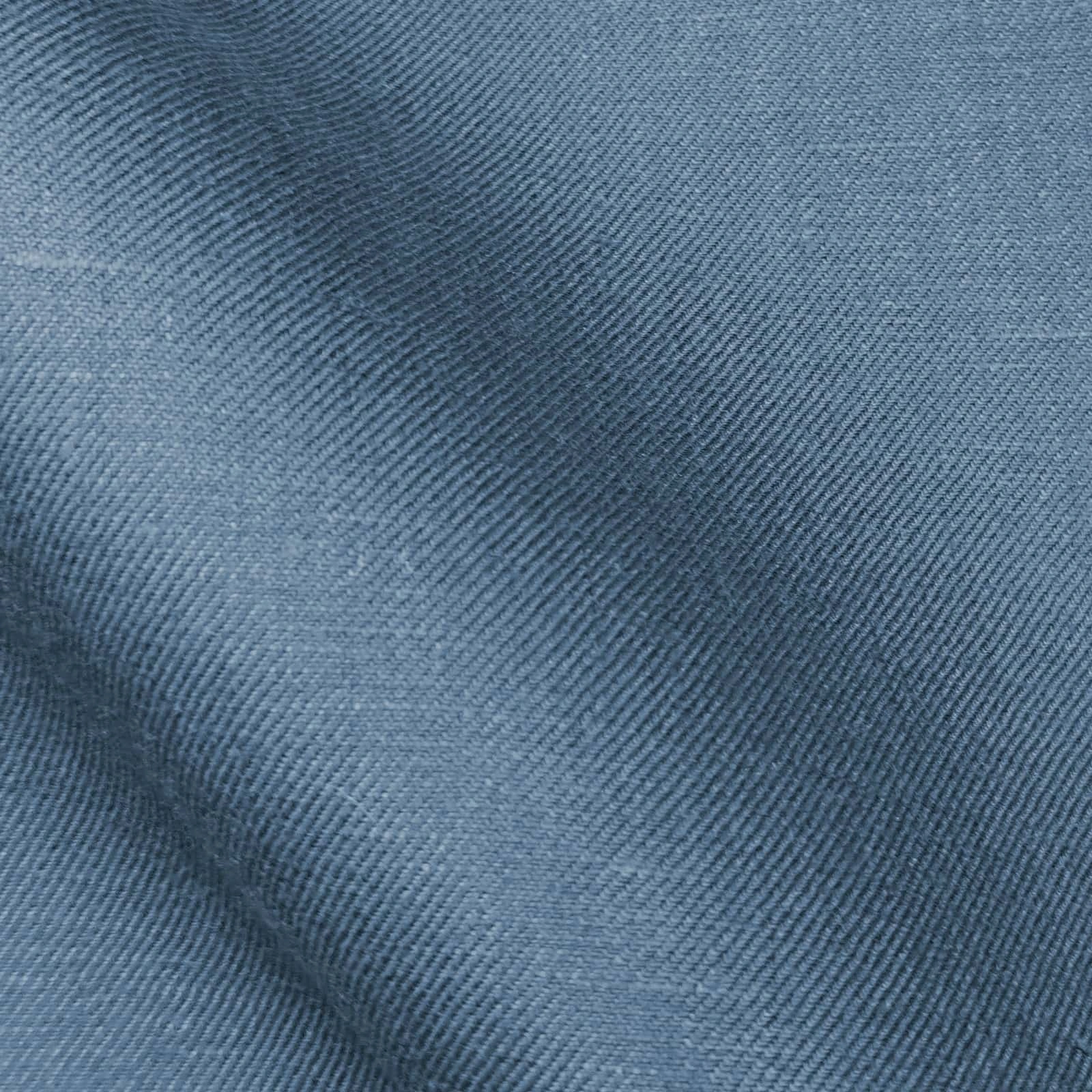 Mid-blue twill linen suiting fabric close-up with fine diagonal weave, crisp structure and soft hand feel—premium breathable linen ideal for summer suits, tailored jackets, business wear, and refined menswear styling.