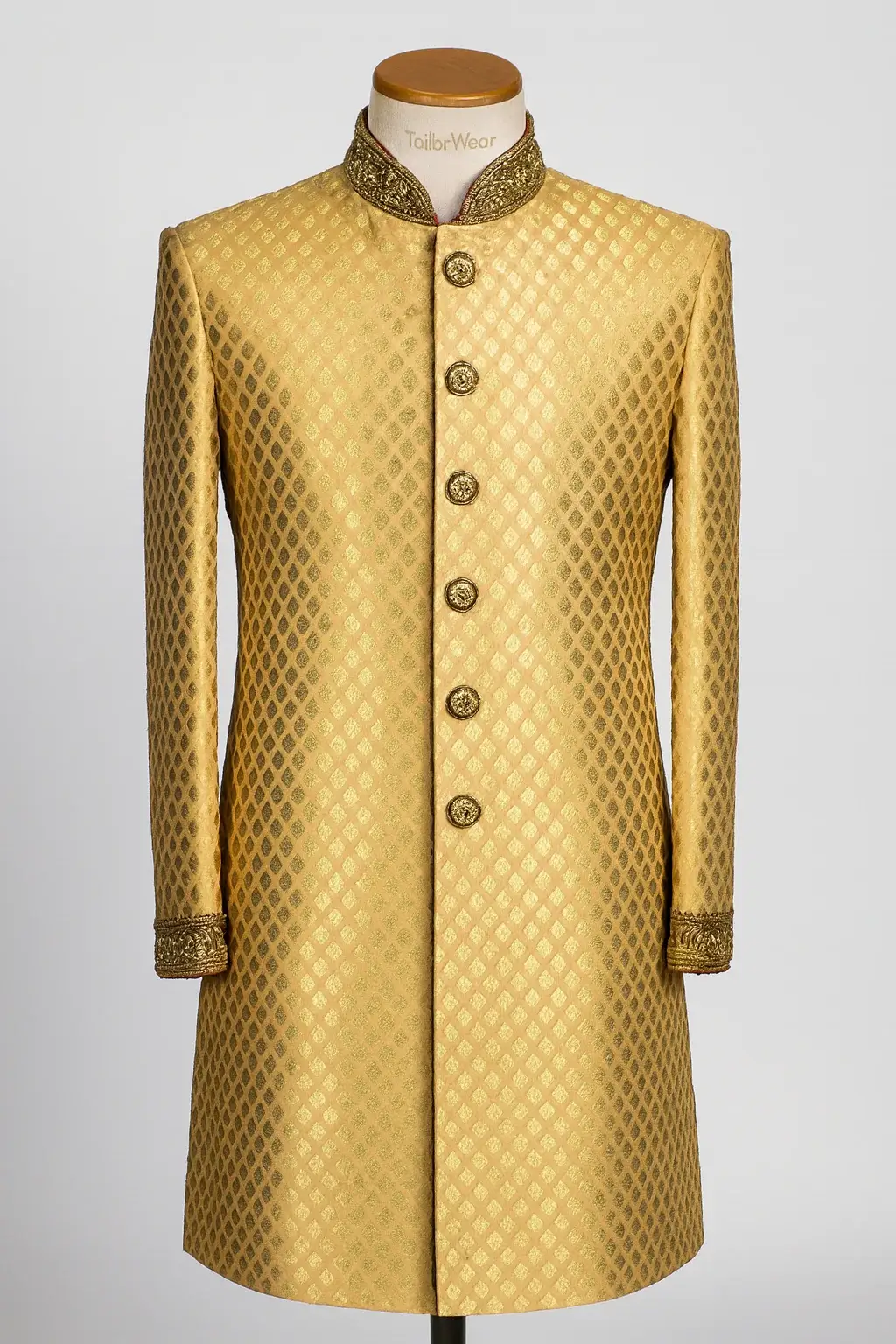 Tailorwear bespoke golden sherwani with vintage Mughal motifs; a heavy jacquard wedding ensemble for men seeking a traditional, majestic ethnic look.