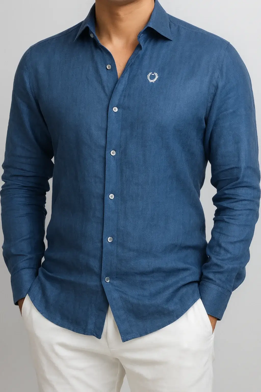 Bespoke men’s blue linen shirt crafted from authentic Baird McNutt Irish linen, featuring custom chest embroidery and a timeless tailored fit for luxury resort wear.