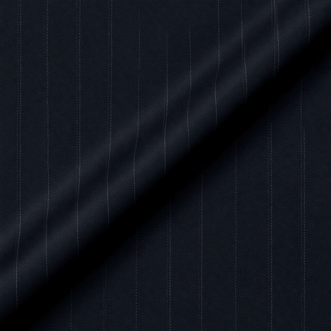 VBC midnight blue striped wool suiting fabric close-up, Super 110s wool with fine pinstripes and smooth drape, premium Italian fabric for business suits, formal tailoring, and bespoke menswear craftsmanship