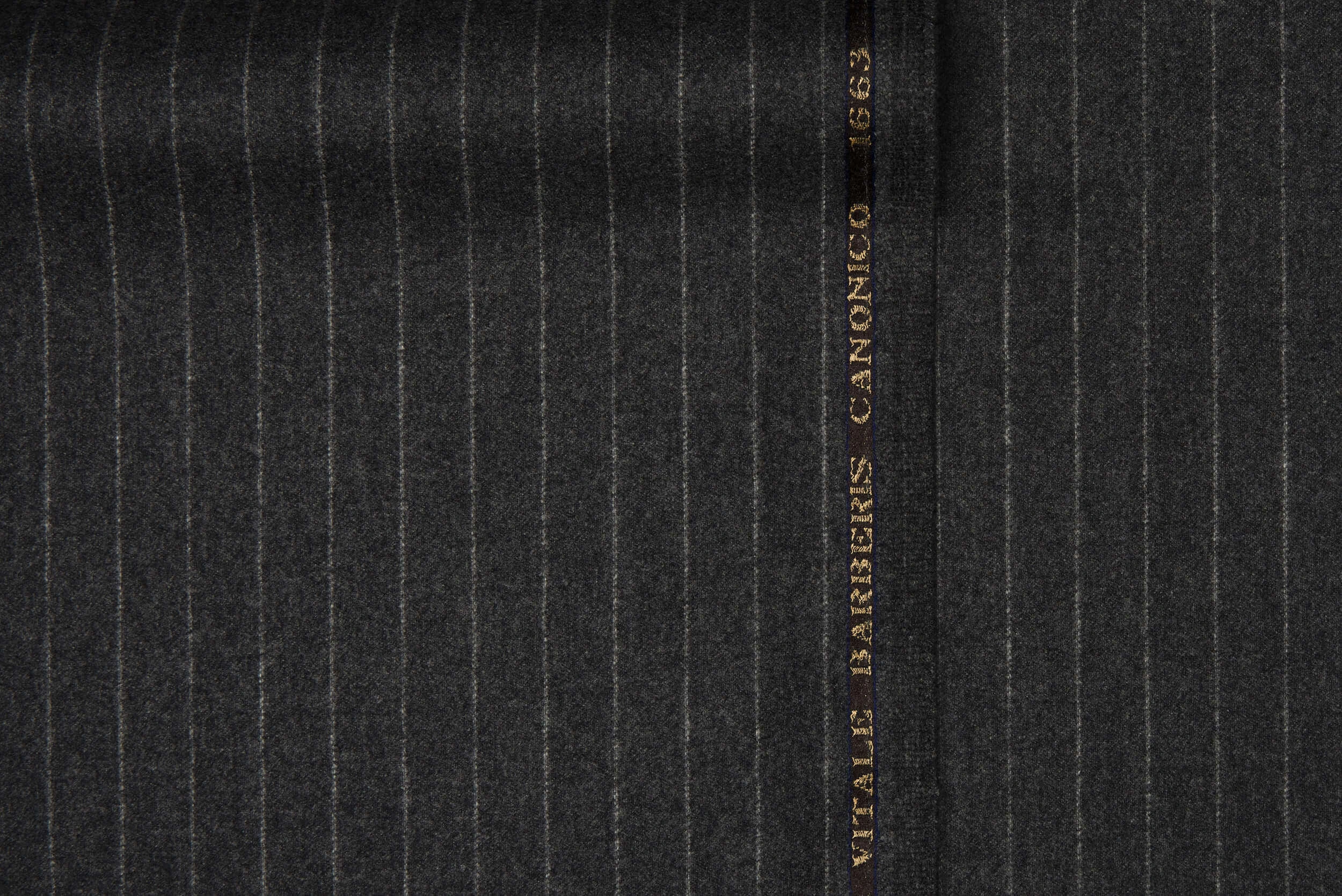 VBC grey flannel striped wool suiting fabric close-up, 340g brushed wool with soft texture and vertical pinstripes, luxury Italian fabric for winter suits, business tailoring, and bespoke formal menswear craftsmanship